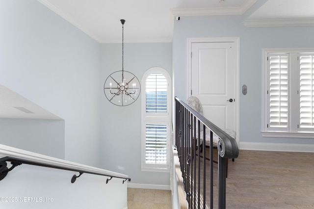 staircase featuring a notable chandelier and ornamental molding