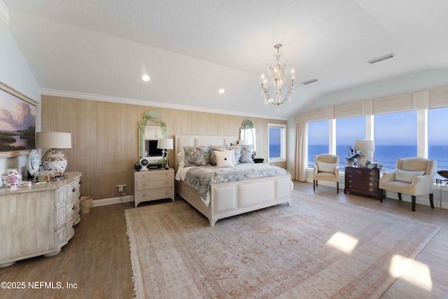 bedroom featuring vaulted ceiling, crown molding, a water view, light hardwood / wood-style flooring, and a notable chandelier