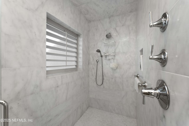 bathroom featuring a tile shower