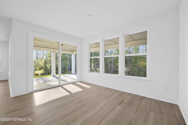 unfurnished room with hardwood / wood-style floors