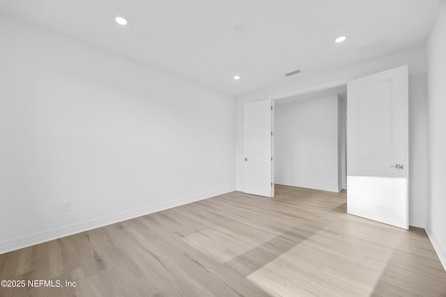 spare room with light wood-type flooring