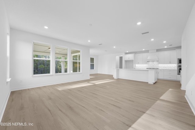 unfurnished living room featuring light hardwood / wood-style floors