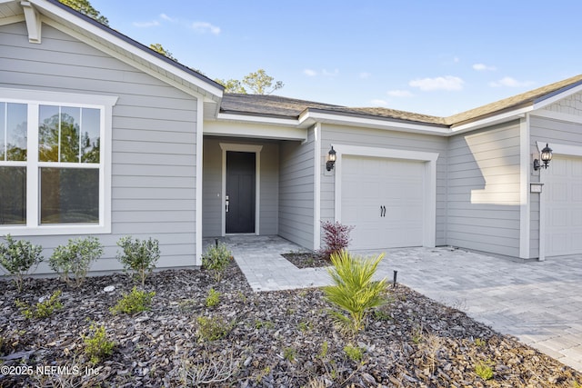 view of exterior entry with a garage