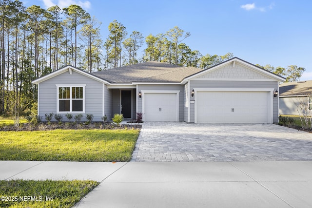 ranch-style home with a front lawn and a garage