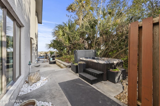 view of patio with a hot tub