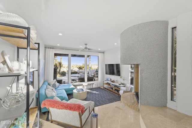 living room with tile patterned flooring and ceiling fan