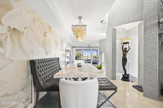 dining room featuring ceiling fan with notable chandelier