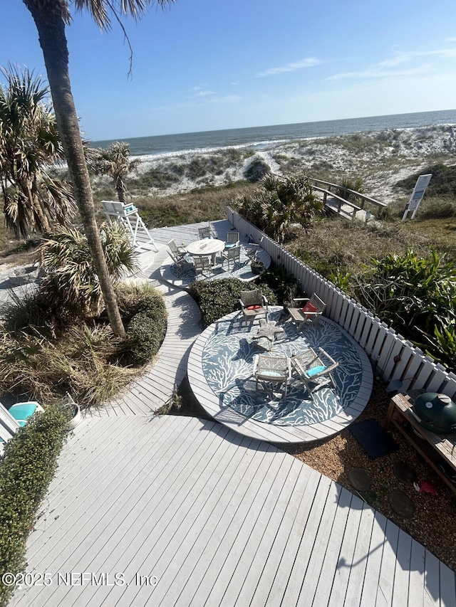 bird's eye view with a water view and a view of the beach