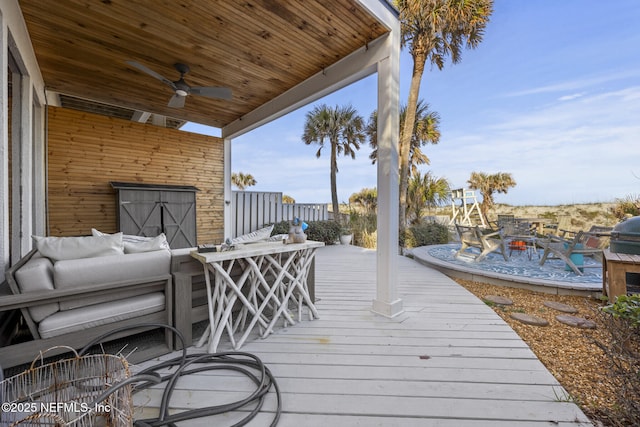 deck featuring an outdoor living space and ceiling fan