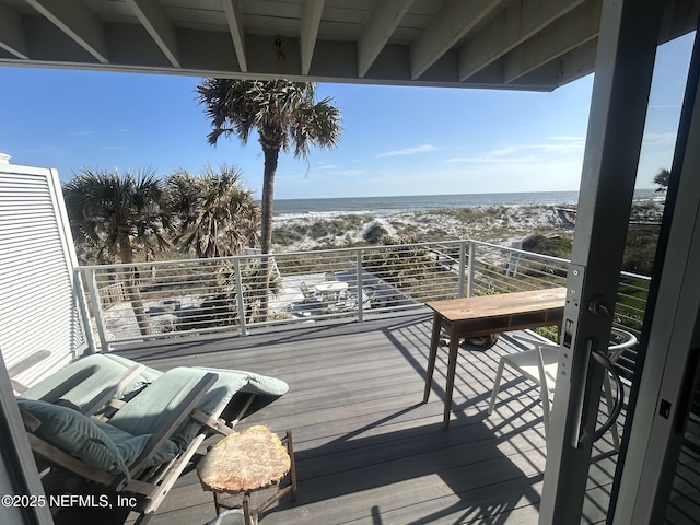 wooden terrace with a water view and a beach view