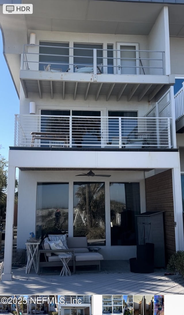 rear view of property featuring an outdoor hangout area and a balcony