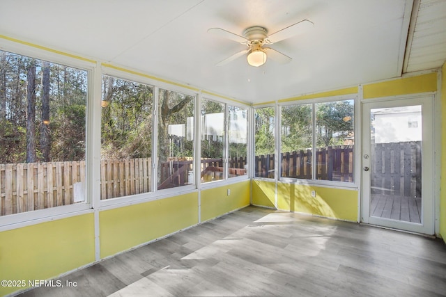 unfurnished sunroom featuring plenty of natural light and ceiling fan