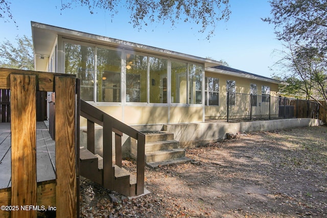 view of home's exterior with a sunroom