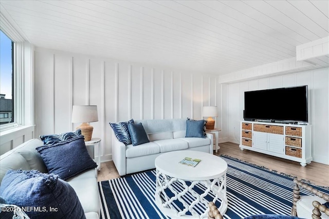 living room featuring hardwood / wood-style floors, wood ceiling, and a healthy amount of sunlight