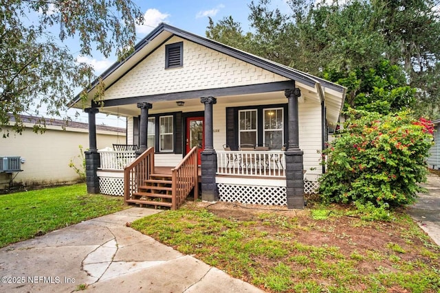 bungalow-style house with covered porch and cooling unit