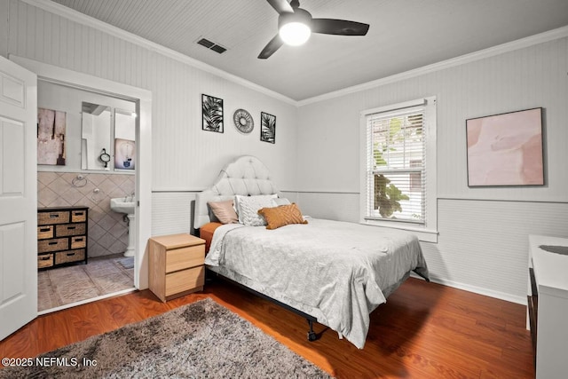 bedroom featuring ceiling fan, hardwood / wood-style floors, and crown molding