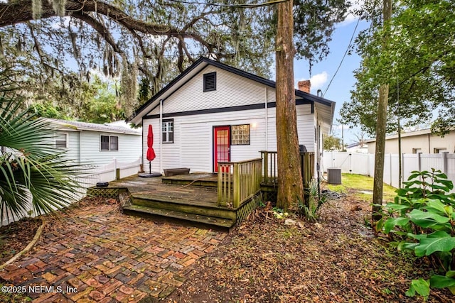 back of property featuring central air condition unit and a wooden deck