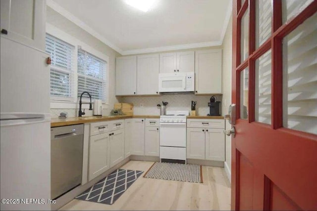 kitchen featuring white cabinets, light hardwood / wood-style floors, white appliances, and sink