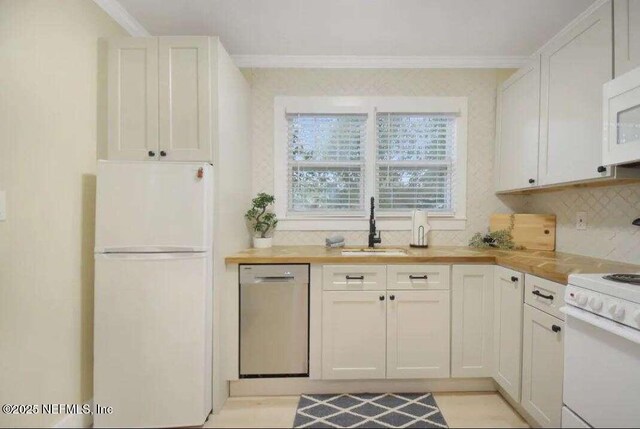 kitchen with white cabinetry, white appliances, and sink