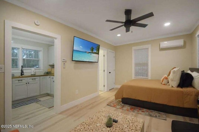 bedroom featuring ensuite bathroom, ceiling fan, light wood-type flooring, ornamental molding, and a wall mounted AC