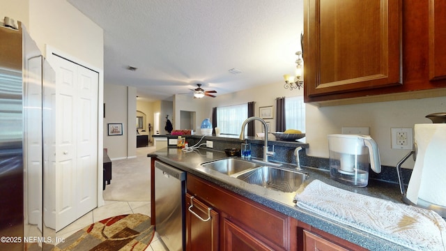 kitchen with sink, ceiling fan, light tile patterned floors, a textured ceiling, and appliances with stainless steel finishes