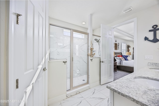 bathroom with a wealth of natural light, vanity, and walk in shower