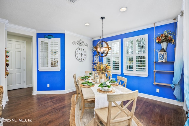 dining area with a notable chandelier, dark hardwood / wood-style floors, and ornamental molding