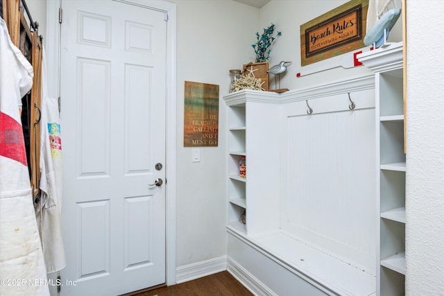 mudroom with a barn door and dark hardwood / wood-style flooring