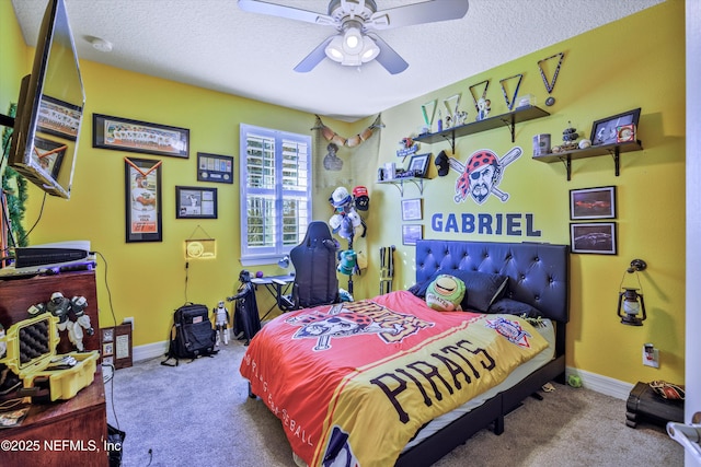 carpeted bedroom featuring ceiling fan and a textured ceiling