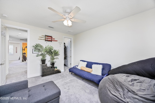 carpeted living room with ceiling fan