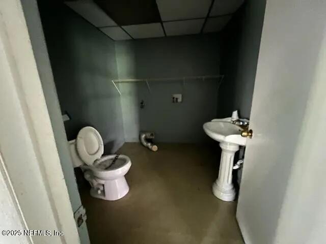 bathroom featuring a paneled ceiling and toilet