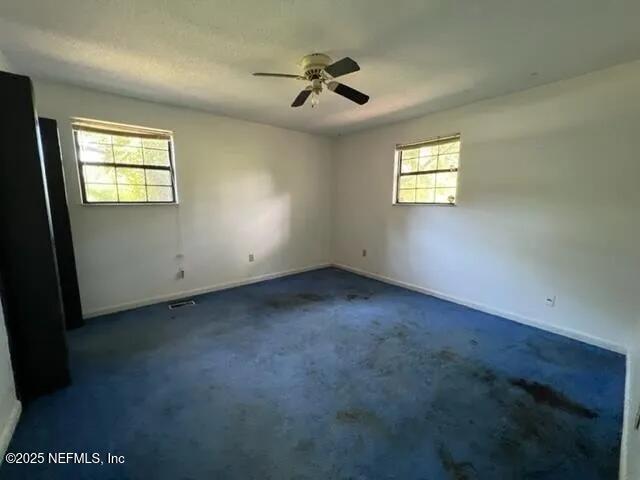 carpeted empty room with ceiling fan