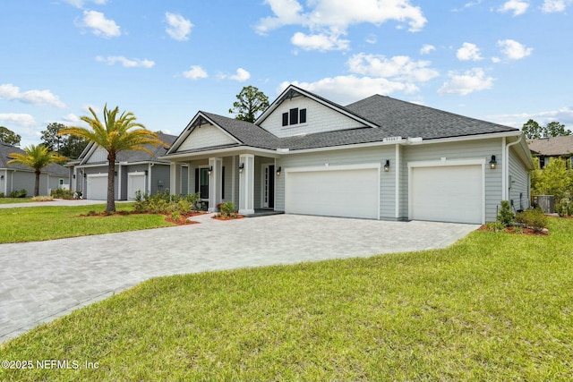 view of front of property featuring a garage and a front yard