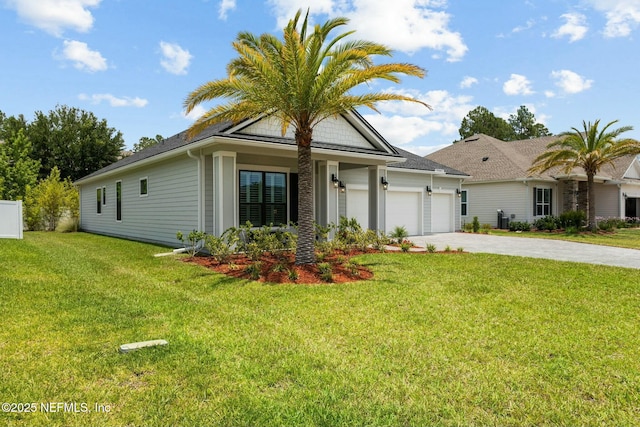 view of front facade with a front yard and a garage