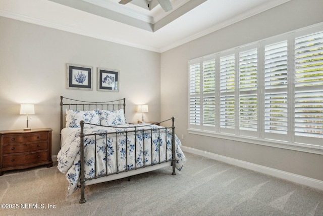 bedroom with ceiling fan, light colored carpet, ornamental molding, and a tray ceiling