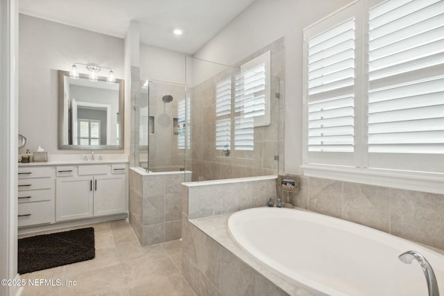 bathroom featuring separate shower and tub, a wealth of natural light, tile patterned flooring, and vanity