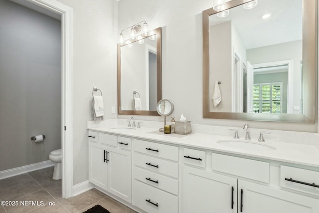 bathroom featuring tile patterned floors, vanity, and toilet