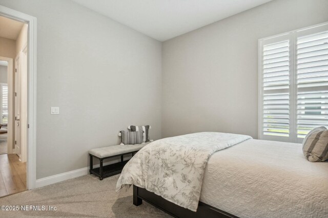 carpeted bedroom with multiple windows