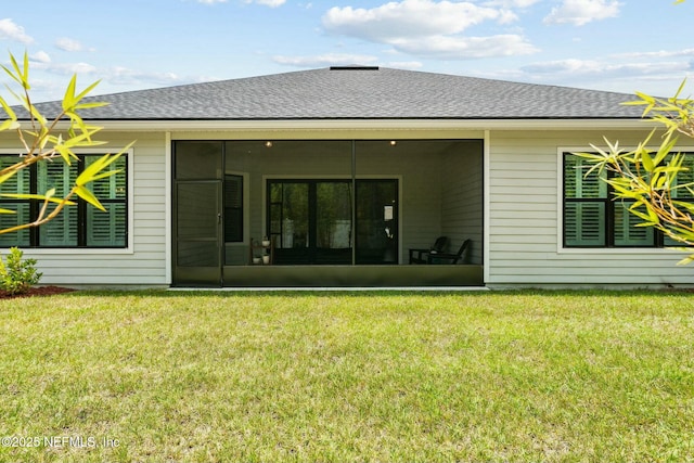 back of house with a sunroom and a yard