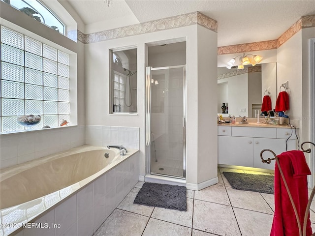 bathroom featuring vanity, tile patterned flooring, plus walk in shower, and a textured ceiling