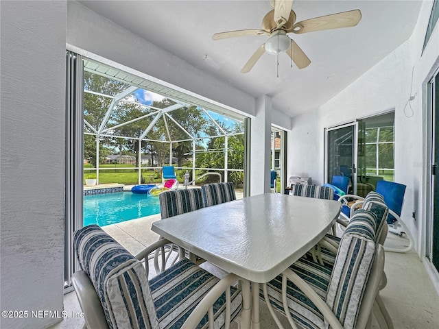 view of patio / terrace with ceiling fan and a lanai