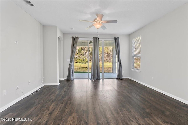 empty room featuring ceiling fan and dark wood-type flooring