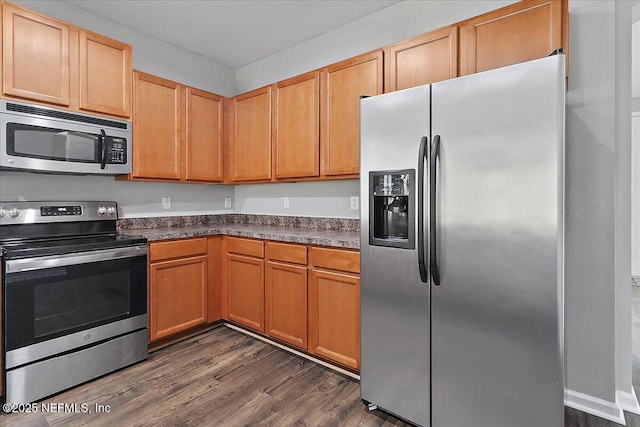 kitchen featuring dark hardwood / wood-style flooring and appliances with stainless steel finishes