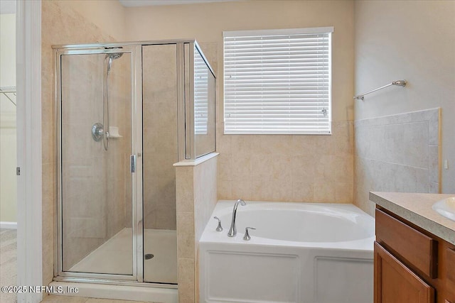 bathroom with shower with separate bathtub, vanity, and a healthy amount of sunlight