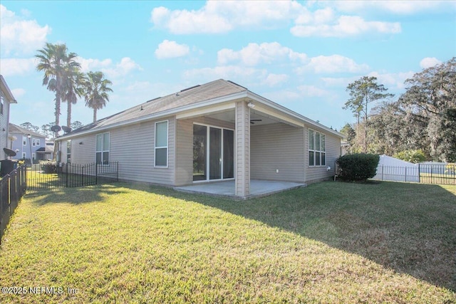 back of house with a lawn and a patio