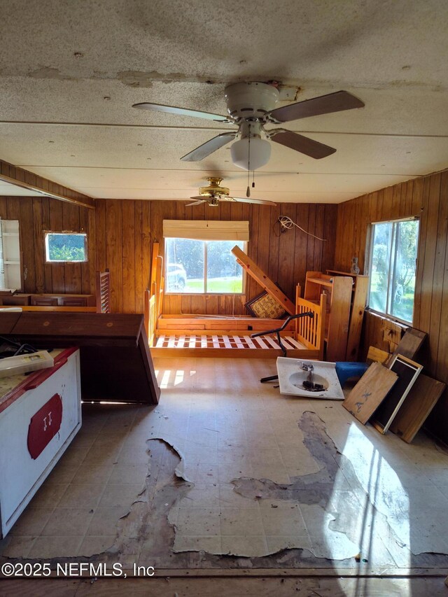 interior space with multiple windows and wood walls