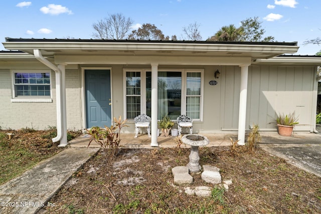 view of exterior entry with covered porch