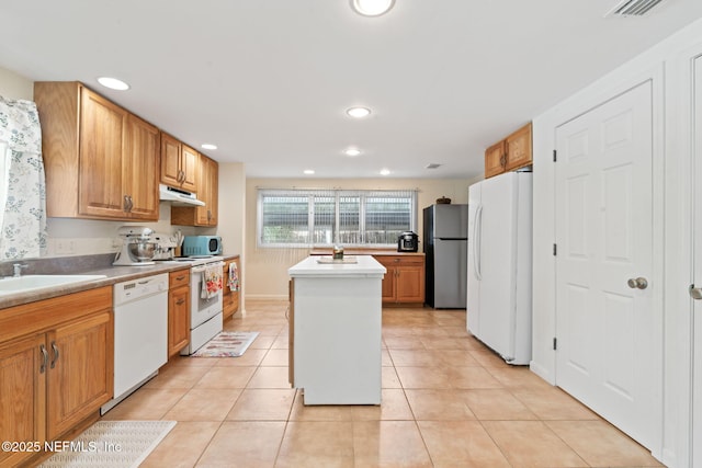 kitchen featuring stainless steel appliances, light tile patterned flooring, a center island, and sink