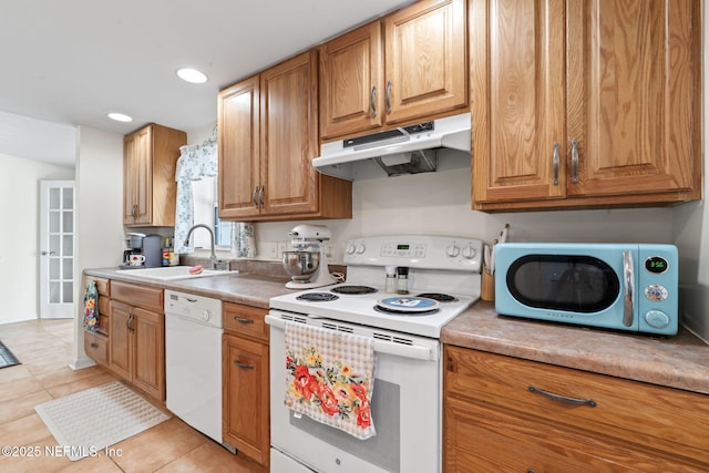 kitchen with light tile patterned flooring, white appliances, and sink