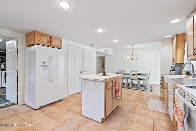 kitchen with sink, light tile patterned floors, hanging light fixtures, white fridge with ice dispenser, and a kitchen island